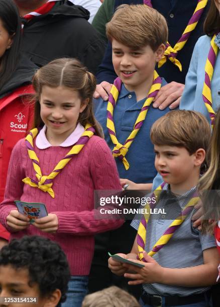 Britain's Prince George of Wales , Britain's Prince Louis of Wales and Britain's Princess Charlotte of Wales pose for a group picture with volunteers...