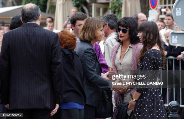 French Culture Minister Christinre Albanel comforts Nathalie Serrault and Gwendoline Courreges , daughter and grand-daughter of French actor Michel...