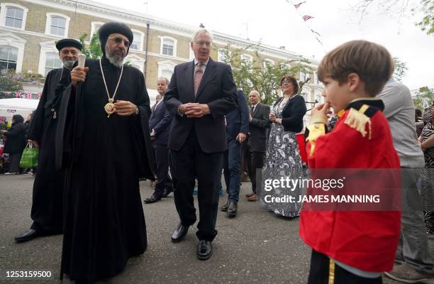 Coptic Orthodox Archbishop of London, Archbishop Angaelos walks with Britain's Prince Richard, Duke of Gloucester as the meet members of the public...