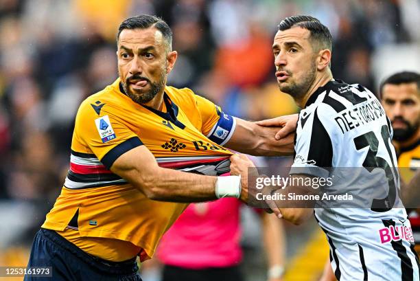 Fabio Quagliarella of Sampdoria gets body-checked by Ilija Nestorovski of Udinese during the Serie A match between Udinese Calcio and UC Sampdoria at...