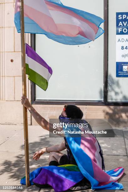 Protester holds the transgender and genderqueer flags during the Pride Without Prejudice march on June 28, 2020 in Chicago, Illinois. The march...