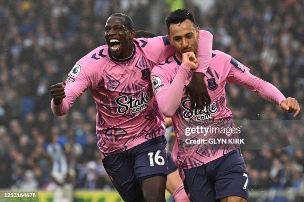 Everton's England midfielder Dwight McNeil celebrates with Everton's French midfielder Abdoulaye Doucoure after scoring their fourth goal during the...
