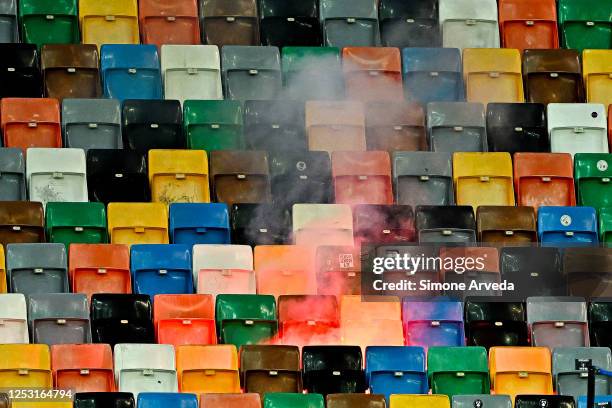 Smoke-bomb thrown by fans of Udinese burns on the stands during the Serie A match between Udinese Calcio and UC Sampdoria at Dacia Arena on May 8,...