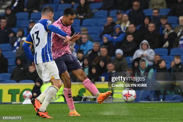 Everton's England midfielder Dwight McNeil shoots to score their fifth goal during the English Premier League football match between Brighton and...