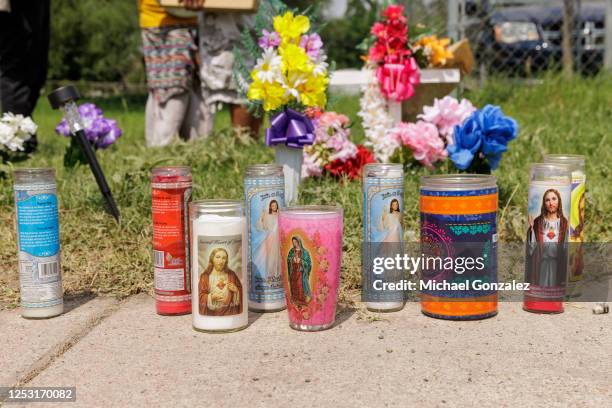 Votive candles setup at a memorial at a vigil for 8 migrants that were run over and killed yesterday waiting at a bus stop on May 8, 2023 in...