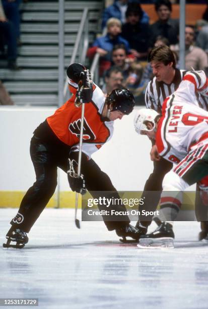 Darryl Sittler of the Philadelphia Flyers faces off against Don Lever of the New Jersey Devils during an NHL Hockey game circa 1983 at the Brendan...