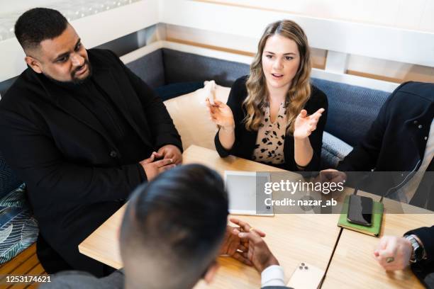 woman taking lead in a meeting. - new zealand small business stock pictures, royalty-free photos & images