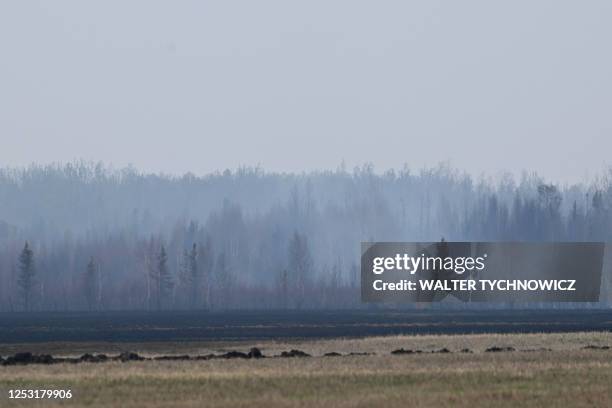 Smoke billows from a still-smouldering fire outside of Drayton Valley, Alberta, Canada, on May 8, 2023. - Canada struggled on Monday to control...