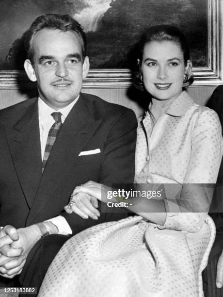 Prince Rainier III of Monaco and his fiancee US actress Grace Kelly with her engagement ring pose on January 05, 1956 at the Philadelphia county club...