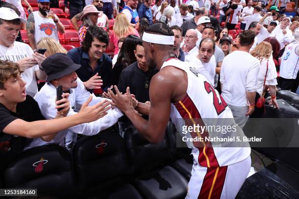 Jimmy Butler of the Miami Heat takes photos with fans after Game Four of the Eastern Conference Semi-Finals of the 2023 NBA Playoffs against the New...