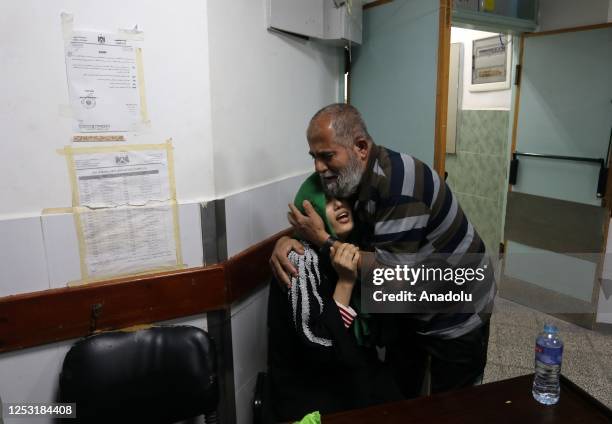 Relatives of a Palestinian man who was killed during Israeli warplanes airstrikes mourn at the mortuary of the Abu Yusuf al-Najjar Hospital in Rafah,...