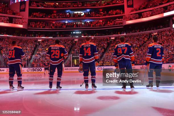 Evander Kane, Leon Draisaitl, Mattias Ekholm, Connor McDavid and Evan Bouchard of the Edmonton Oilers stand for the playing of the national anthem...