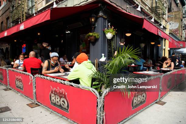 New York, New York Diners are seated outdoors at a restaurant on the street in East Village as re-opening continues across densely populated New York...