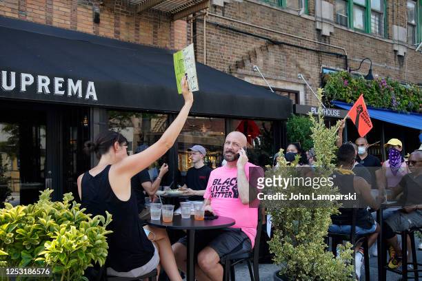 New York, New York Diners are seated outdoors at a restaurant on the street in West Village as re-opening continues across densely populated New York...