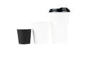 A row of paper coffee cups on a white background.Glasses for coffee and tea of different sizes isolated on white background. Hot coffee, starbucks.