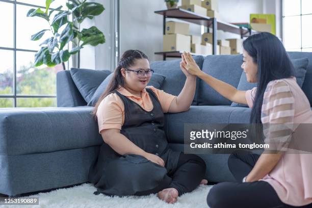 portrait of a mother with daughter autism and down syndrome in daily lives - bottomless girl fotografías e imágenes de stock