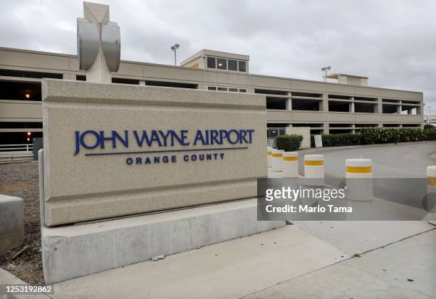 Sign is displayed at John Wayne Airport, located in Orange County, on June 28, 2020 in Santa Ana, California. Orange County Democrats are calling for...