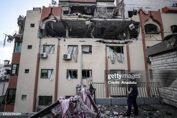 Palestinian man examines damaged buildings after the airstrikes carried out by the Israeli military, working with Israel's Shin Bet internal security...