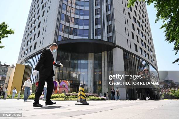 Man walks past the entrance of the building where Canada's consul general facilities are located in Shanghai on May 9, 2023.