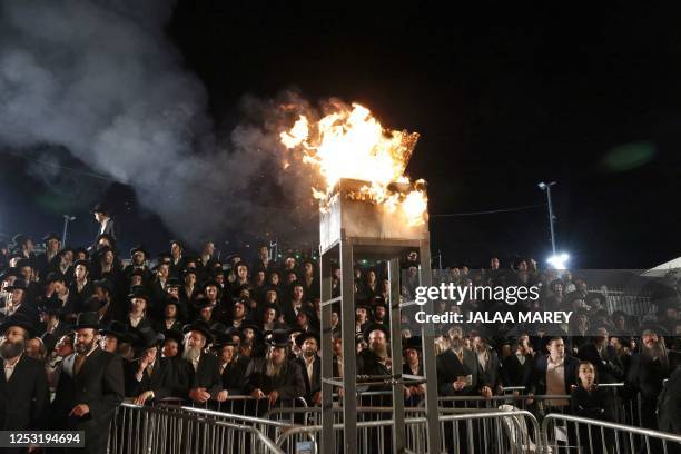 Ultra-Orthodox Jews gather around a bonfire at the gravesite of Rabbi Shimon Bar Yochai at Mount Meron in northern Israel on May 9 during the Jewish...