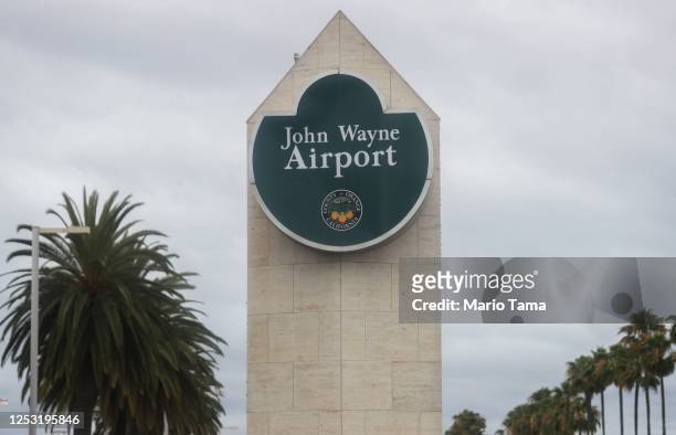 Sign is displayed at John Wayne Airport, located in Orange County, on June 28, 2020 in Santa Ana, California. Orange County Democrats are calling for...