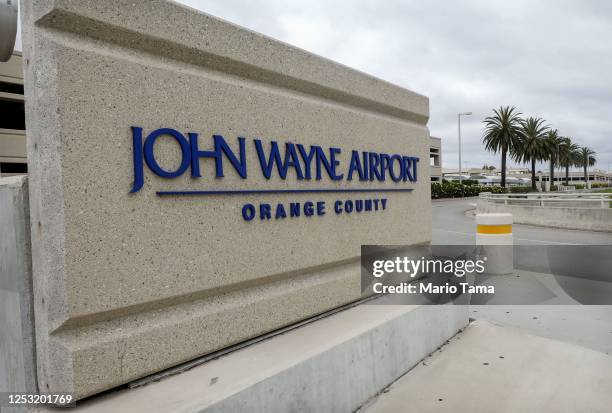 Sign is displayed at John Wayne Airport, located in Orange County, on June 28, 2020 in Santa Ana, California. Orange County Democrats are calling for...