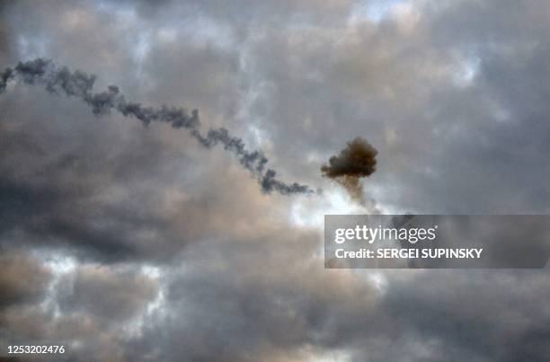 This picture taken early morning on May 9 in Kyiv, shows a smog of explosion after Ukrainian air defence downed missile, amid the Russian invasion of...