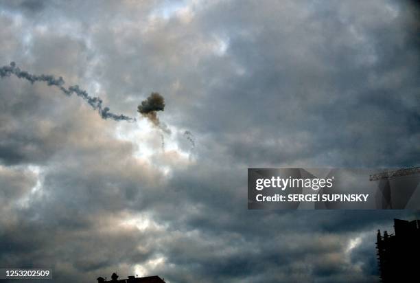 This picture taken early morning on May 9 in Kyiv, shows a smog of explosion after Ukrainian air defence downed missile, amid the Russian invasion of...