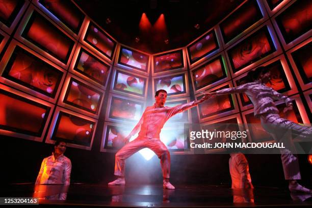 Dancers from the Pilobolus Dance Theatre perform in the "Ambilight TV" stand of Dutch electronics giant Philips at Berlin's IFA Consumer Electronics...