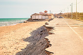 road near the beach collapsed by a sea storm. Climate change