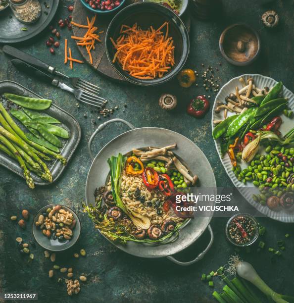 salad buddha bowl with grilled vegetables, edamame soybeans and mushrooms on dark rustic background with ingredients and cutlery. - course meal stock pictures, royalty-free photos & images