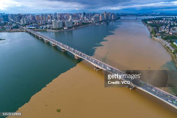 Aerial view of the green-yellow Han River after a heavy rainfall on June 28, 2020 in Xiangyang, Hubei Province of China. Heavy rainfall washes sand...
