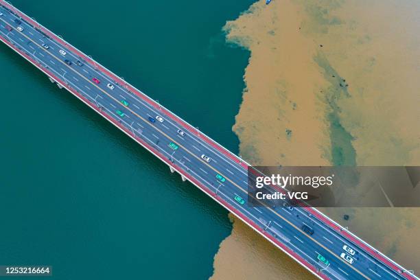 Aerial view of the green-yellow Han River after a heavy rainfall on June 28, 2020 in Xiangyang, Hubei Province of China. Heavy rainfall washes sand...
