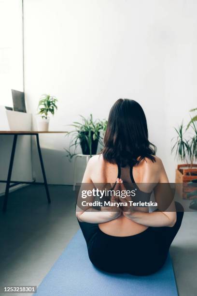 girl in uniform meditates in lotus position at home. - scapula stock pictures, royalty-free photos & images