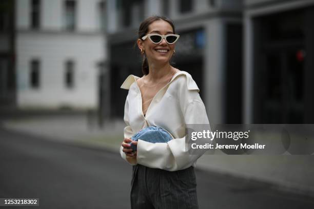 Anna Schürrle wearing Bottega Veneta bag, Alexander Wang blouse, Max Mara pants and Celine shades on June 28, 2020 in Berlin, Germany.