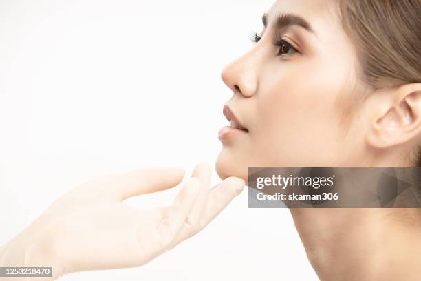 close up asian asian girl beauty face aesthetic with filler lip by syringe white background beauty and surgery lip fillers concept - rinoplastica foto e immagini stock