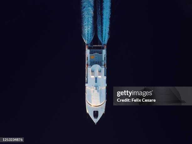 aerial top view of a catamaran passenger ship on the move. world at work drone view. - catamarán fotografías e imágenes de stock