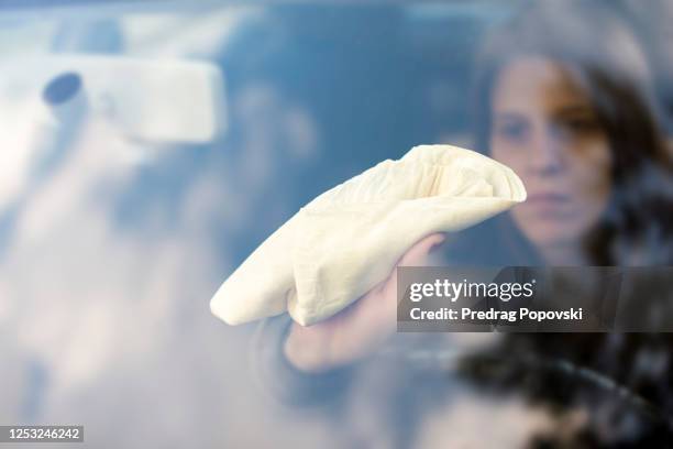 young woman cleaning her car , covid paranoia cleaning concept - inside car stock pictures, royalty-free photos & images