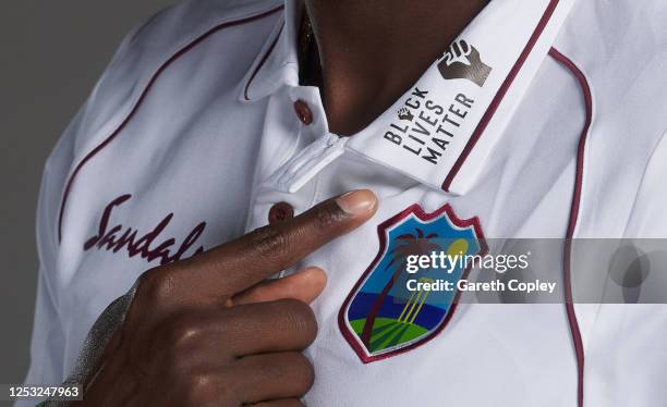 West Indies captain Jason Holder points at the Black Lifes Matter massage on his shirt as he poses for a portrait at Emirates Old Trafford on June...