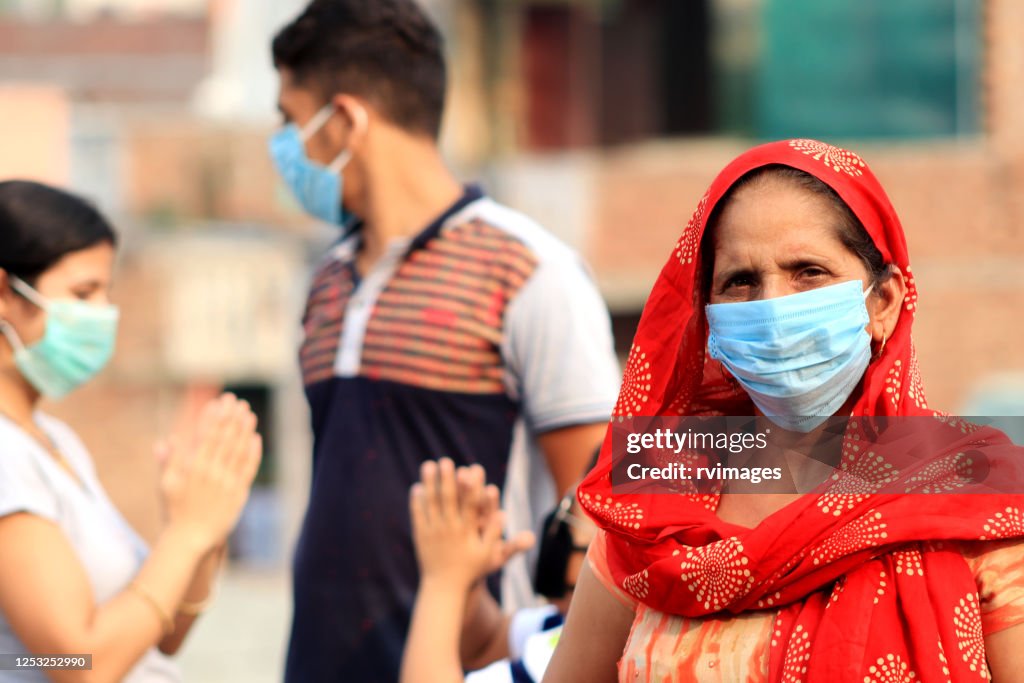 Women covering her face with pollution mask for protection from viruses, COVID-19