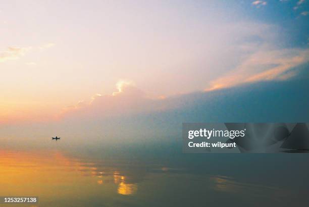 early sunrise fishing on african lake - lake victoria stock pictures, royalty-free photos & images