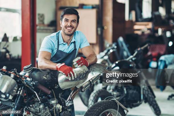 mechanic with a broken down motorcycle - motorcycle mechanic stock pictures, royalty-free photos & images