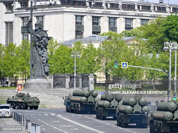 Russian military hardware move past the monument to Vladimir the Great after the Victory Day military parade in central Moscow on May 9, 2023. -...