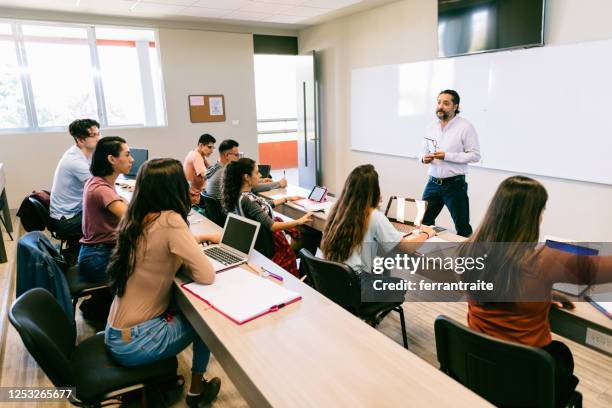 university students in classroom - teacher taking attendance stock pictures, royalty-free photos & images