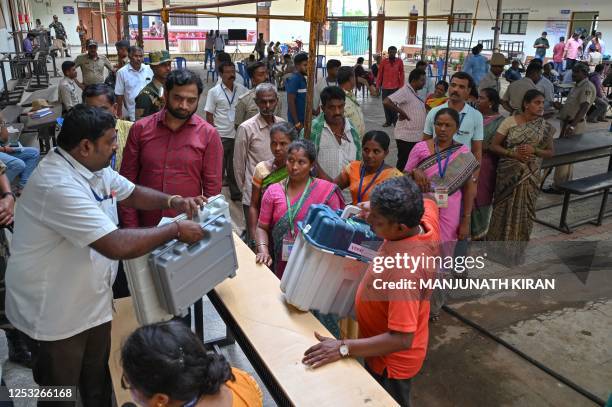 Polling officials collect the electronic voting machines in rural Bengaluru on May 9 on the eve of Karnataka State Legislative Assembly Elections.