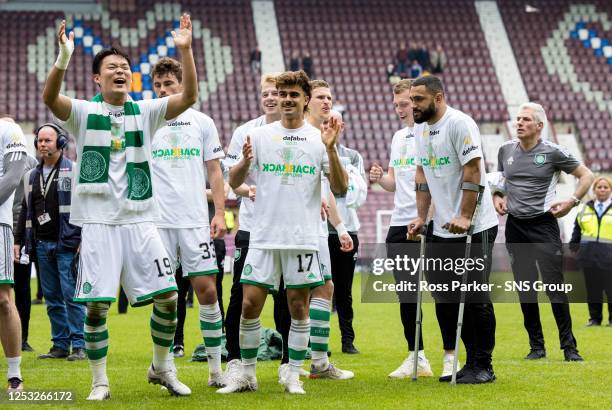 Hyeongyu Oh , Jota and Cameron Carter-Vickers of Celtic celebrate after securing the league title during a cinch Premiership match between Heart of...