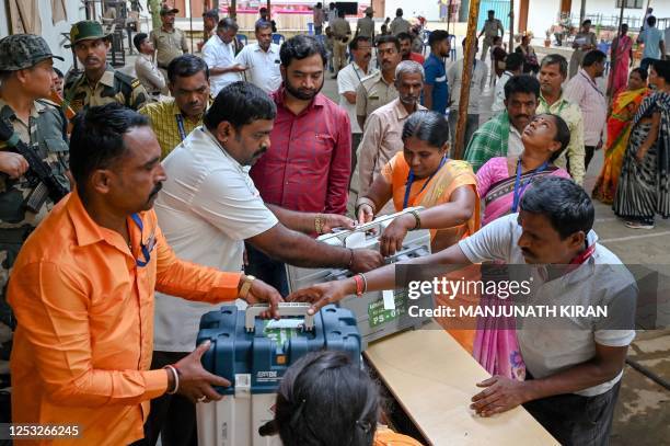 Polling officials collect the electronic voting machines in rural Bengaluru on May 9 on the eve of Karnataka State Legislative Assembly Elections.