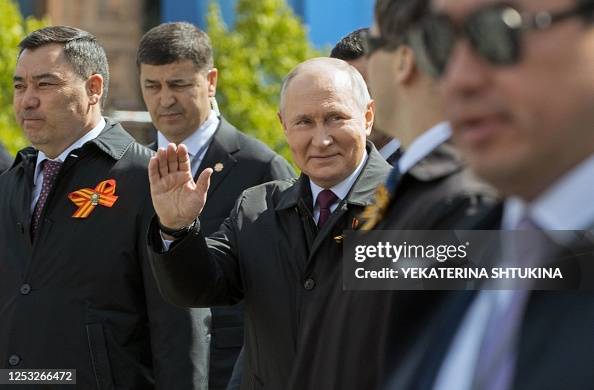 Putin Wave Russian President Vladimir Putin waves as he arrives for the Victory ...