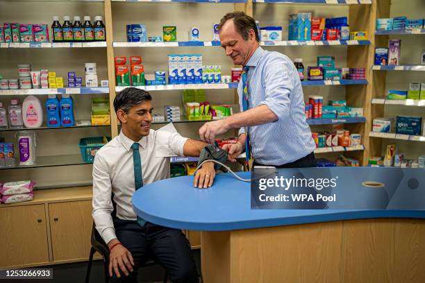 Prime Minister Rishi Sunak has his blood pressure checked by pharmacist Peter Baillie during a visit to a GP surgery and pharmacy in Weston, on May...