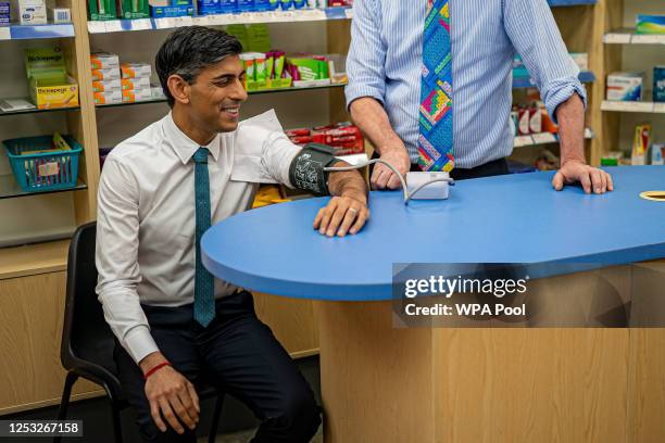 Prime Minister Rishi Sunak has his blood pressure checked by pharmacist Peter Baillie during a visit to a GP surgery and pharmacy in Weston, on May...